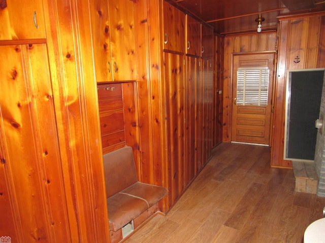 hallway featuring wooden walls and wood-type flooring