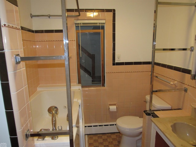 bathroom featuring tile walls, toilet, a baseboard heating unit, a bathtub, and vanity