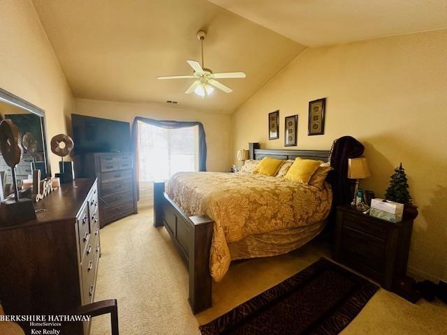 bedroom with light carpet, ceiling fan, and lofted ceiling