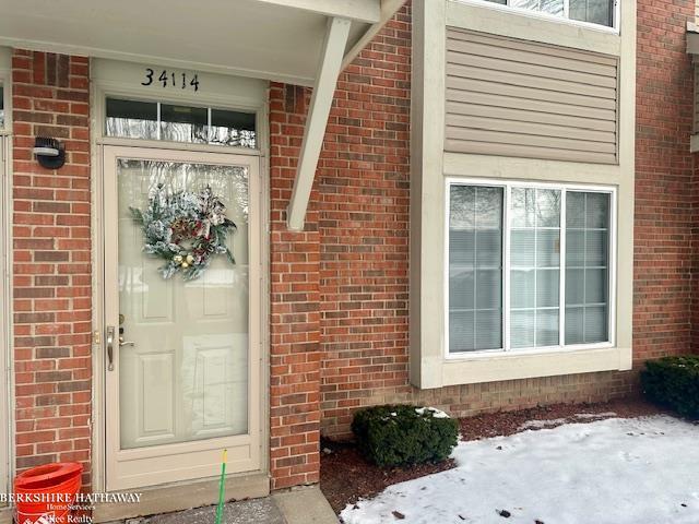 view of snow covered property entrance