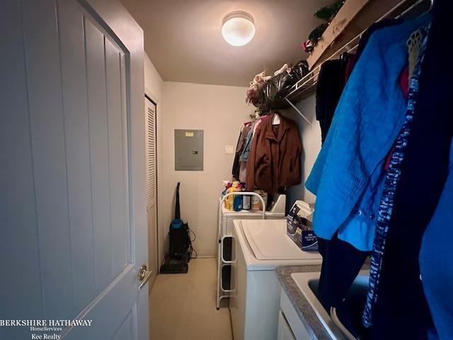 clothes washing area featuring washer and clothes dryer and electric panel