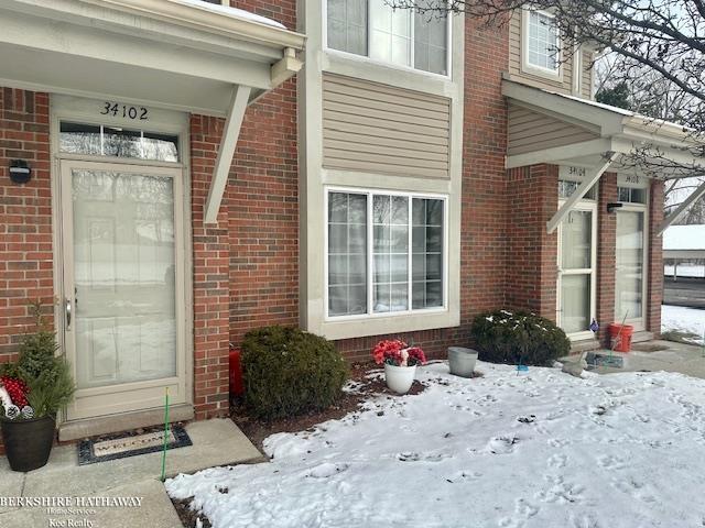 view of snow covered property entrance