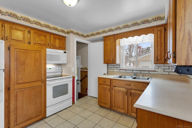 kitchen featuring light tile patterned floors, sink, backsplash, and white appliances