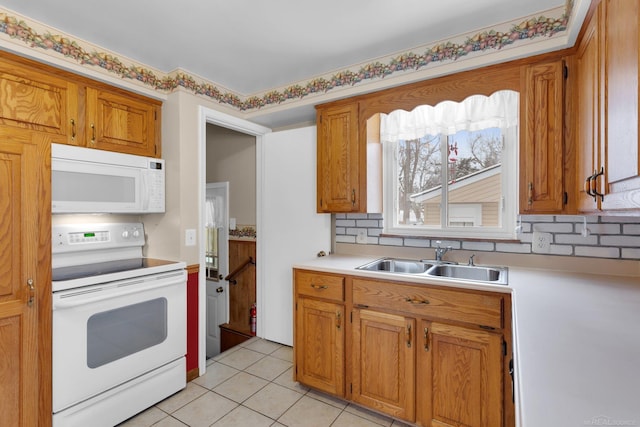 kitchen featuring sink, white appliances, and light tile patterned floors