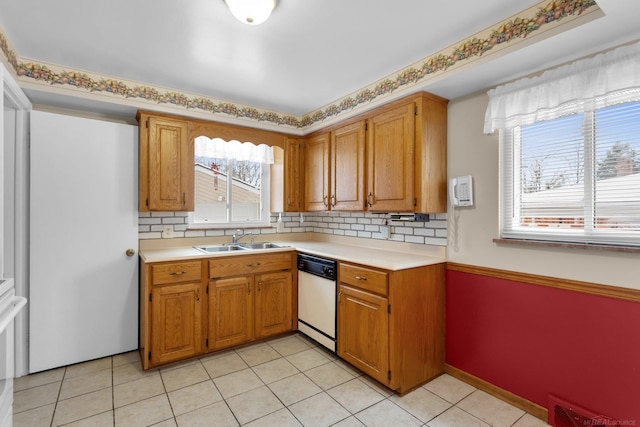 kitchen featuring light tile patterned floors, dishwasher, tasteful backsplash, and sink