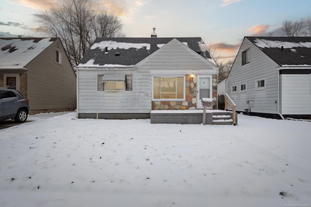 view of snow covered rear of property