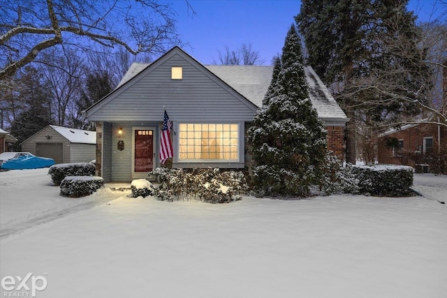 view of front of property featuring an outdoor structure and a garage