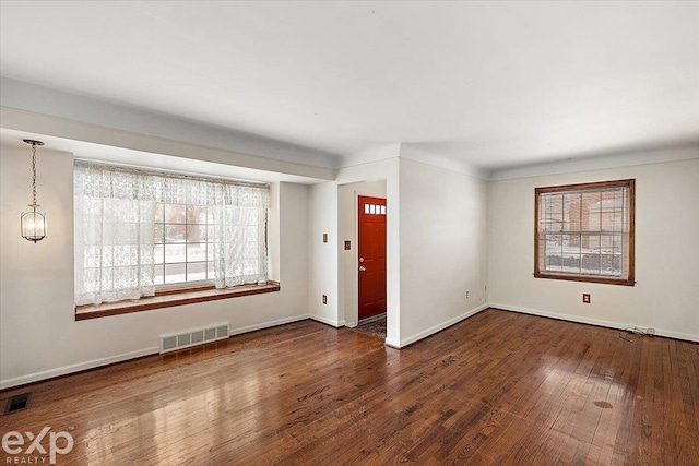 spare room with dark hardwood / wood-style floors