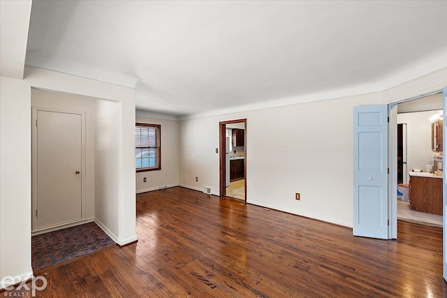 spare room with dark wood-type flooring