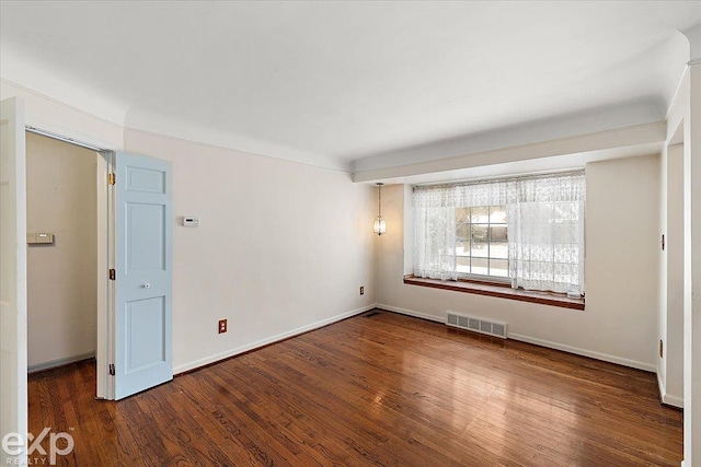 empty room featuring dark hardwood / wood-style floors