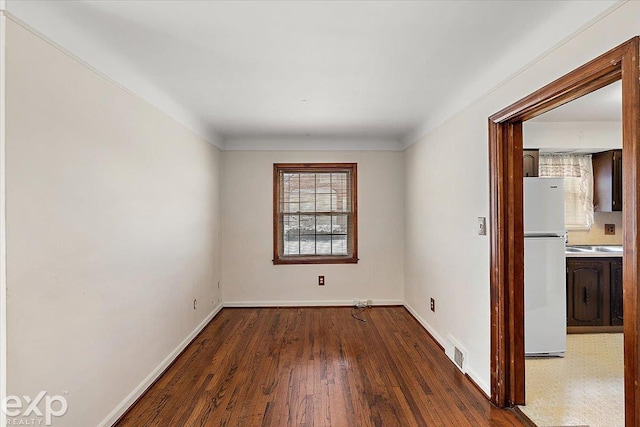 empty room with dark wood-type flooring