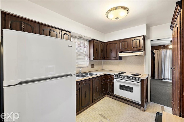 kitchen with sink, white appliances, dark brown cabinets, and tasteful backsplash