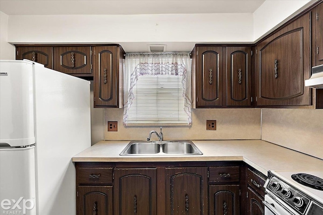 kitchen with sink, white appliances, and dark brown cabinets