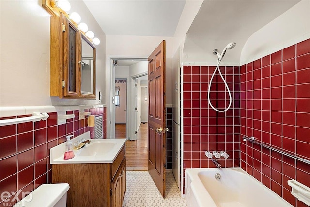 full bathroom featuring bathing tub / shower combination, tile patterned floors, vanity, tile walls, and toilet