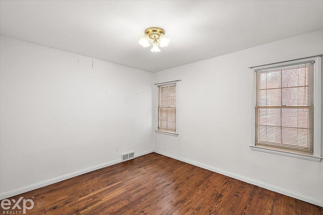 unfurnished room featuring dark hardwood / wood-style flooring