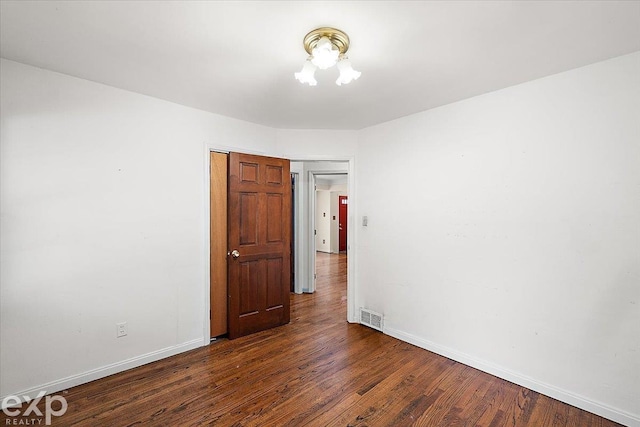 empty room with dark wood-type flooring