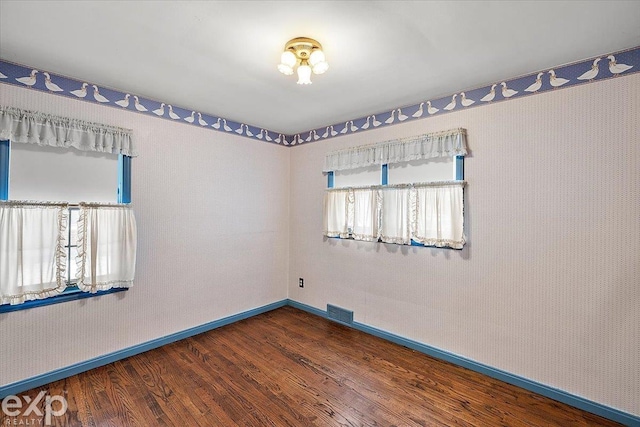 empty room featuring dark hardwood / wood-style flooring