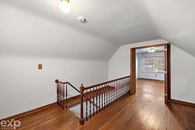 additional living space featuring lofted ceiling and dark wood-type flooring