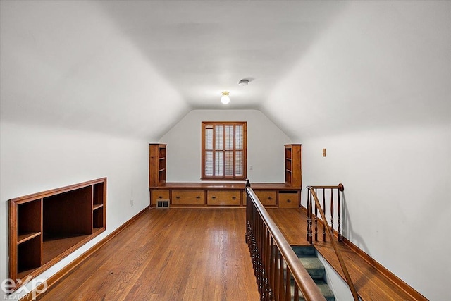 bonus room with lofted ceiling and wood-type flooring