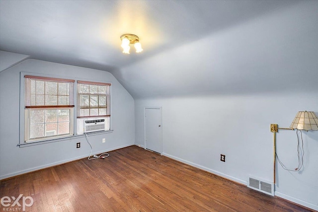 additional living space with lofted ceiling, wood-type flooring, and cooling unit