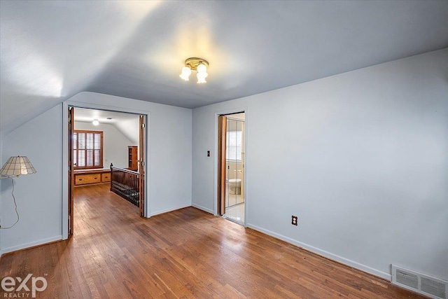 interior space with lofted ceiling and hardwood / wood-style floors