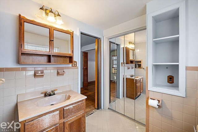 bathroom featuring tile walls, built in features, and vanity