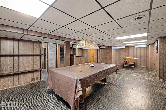 game room with wood walls, pool table, and a drop ceiling