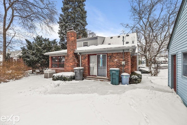 view of snow covered rear of property