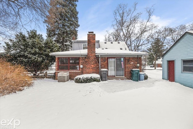 view of snow covered rear of property