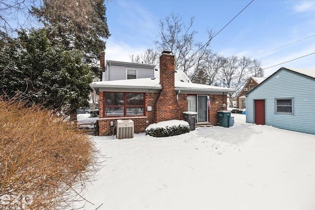 view of snow covered back of property