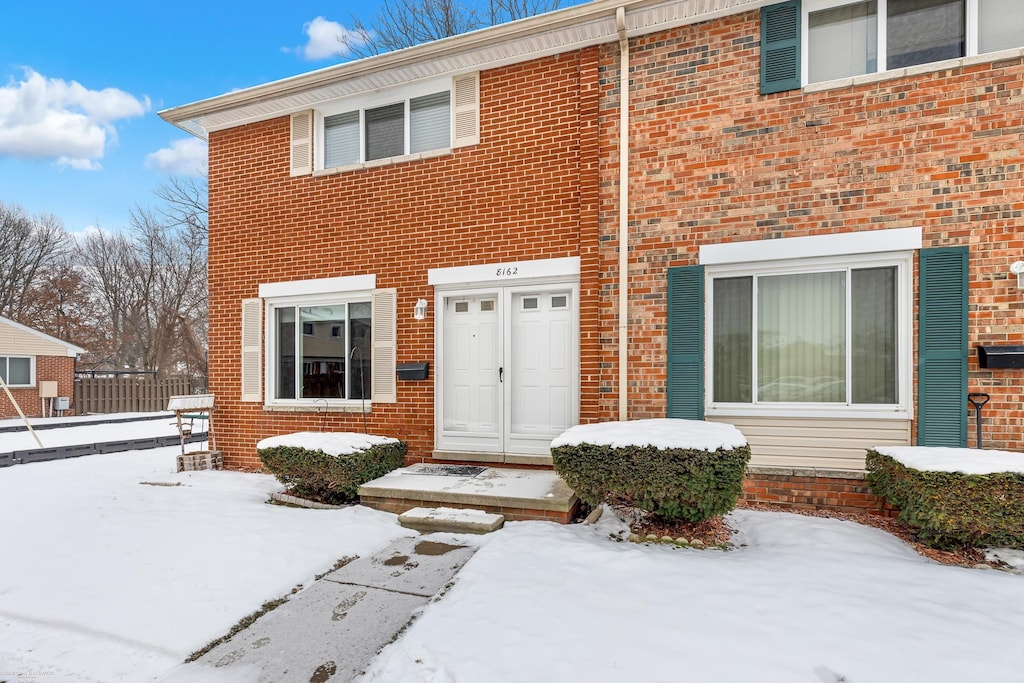 view of snow covered property entrance