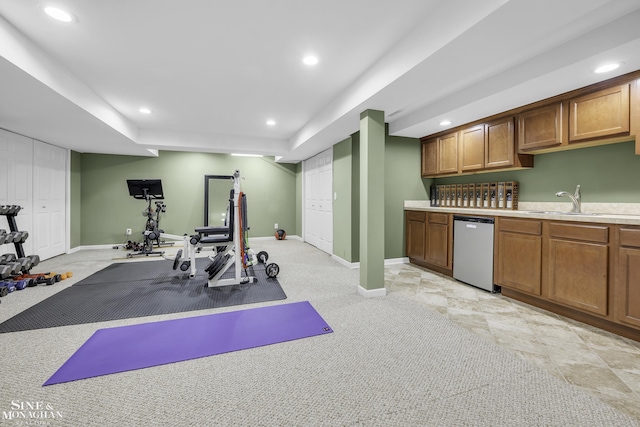 workout room with sink and light carpet