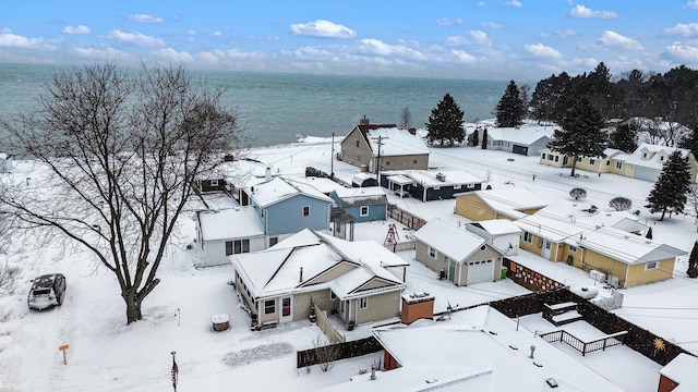 snowy aerial view with a water view