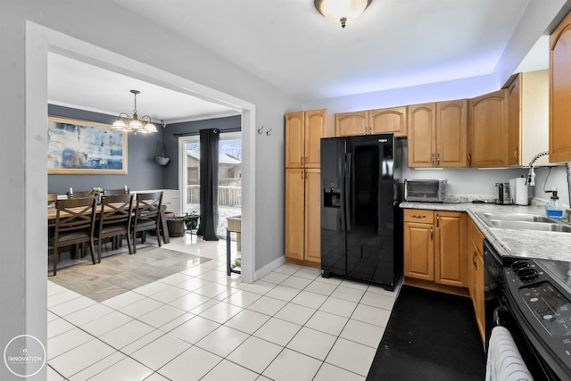 kitchen with pendant lighting, black appliances, sink, a notable chandelier, and light tile patterned floors