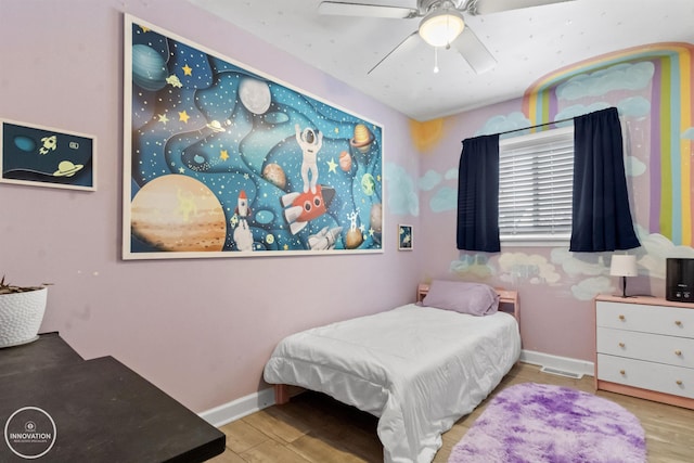 bedroom with ceiling fan and hardwood / wood-style flooring