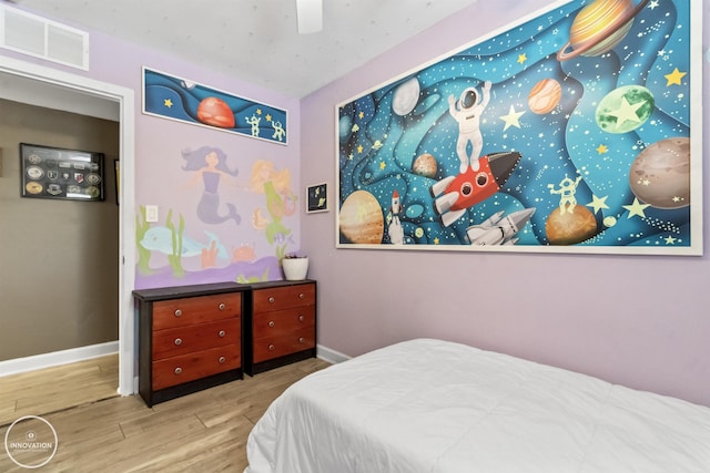 bedroom with ceiling fan and light wood-type flooring