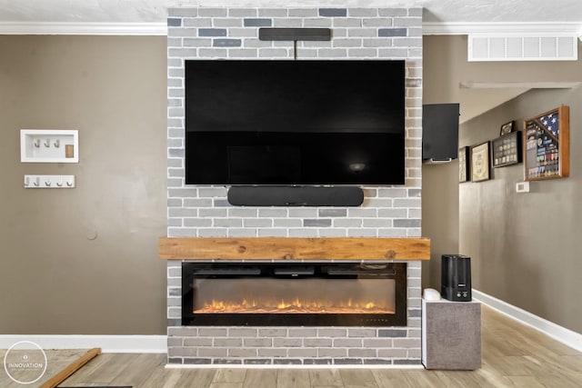 details with wood-type flooring, a fireplace, and ornamental molding