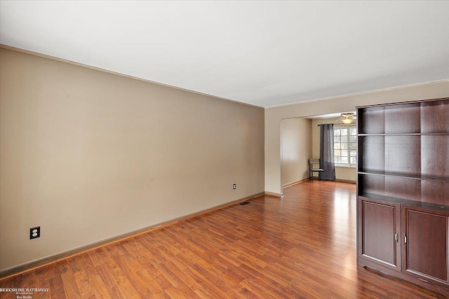 spare room with ceiling fan and hardwood / wood-style flooring