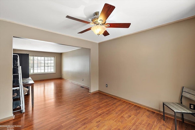 spare room with ceiling fan, ornamental molding, and hardwood / wood-style floors