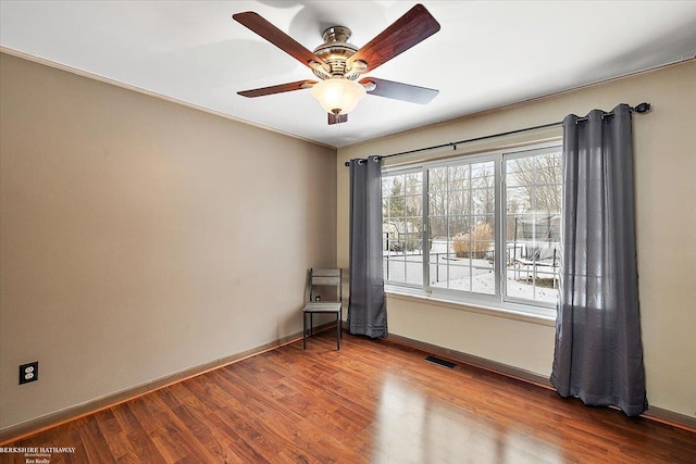 spare room with ceiling fan and wood-type flooring