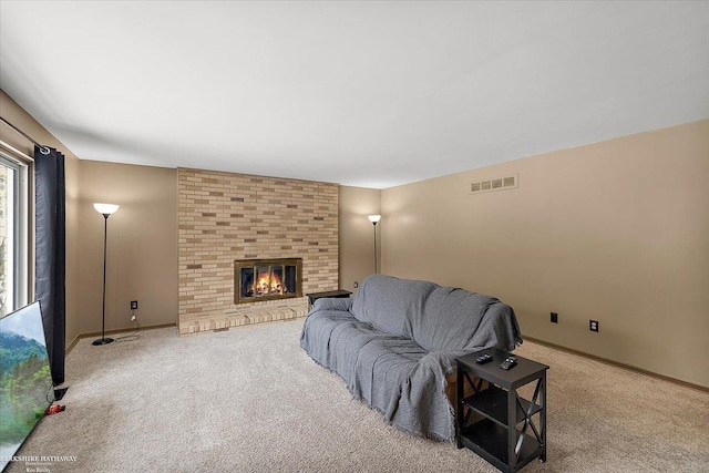 carpeted living room with a fireplace