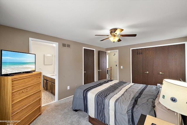 carpeted bedroom featuring ceiling fan and ensuite bathroom