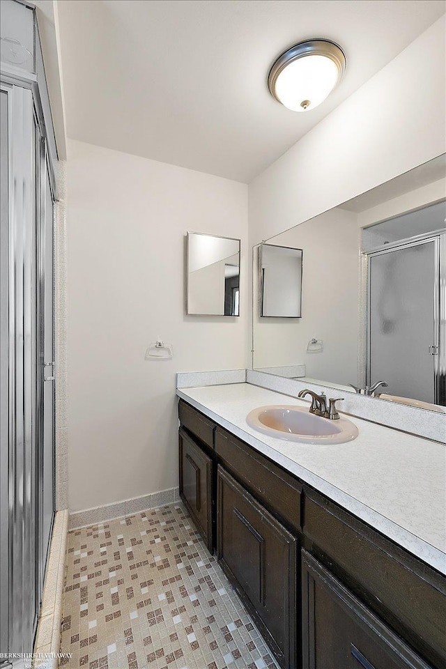 bathroom with vanity, tile patterned flooring, and a shower with door