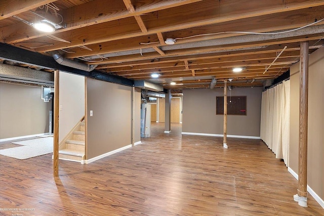 basement with hardwood / wood-style flooring