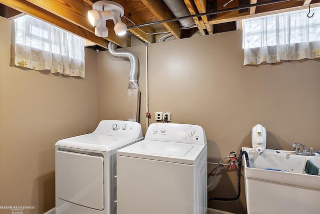 laundry area featuring sink and washing machine and clothes dryer