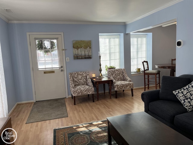 living room featuring light wood-type flooring and ornamental molding