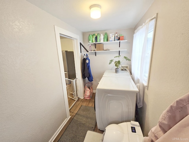 laundry area with washer and dryer and hardwood / wood-style flooring