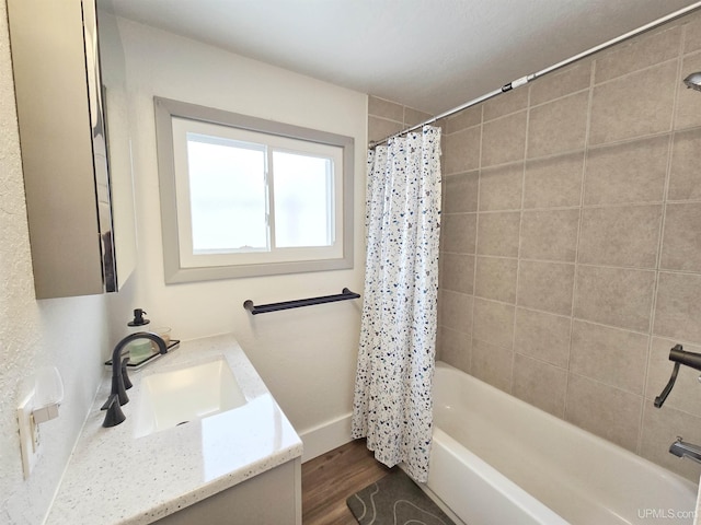 bathroom featuring vanity, wood-type flooring, and shower / bath combo