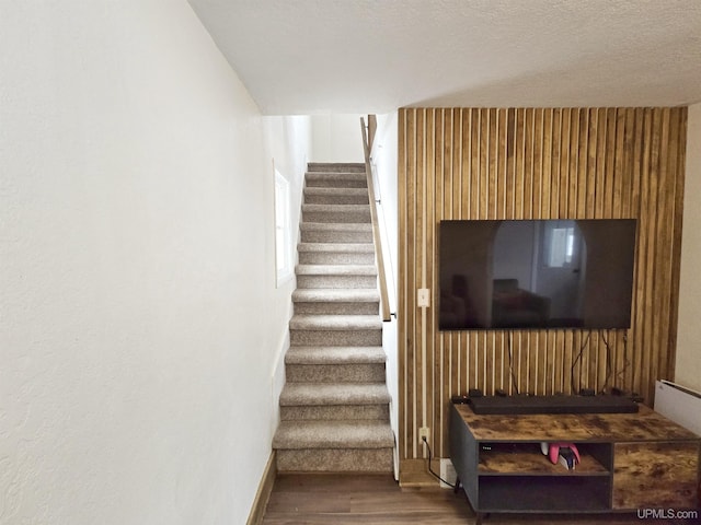 staircase featuring wood-type flooring