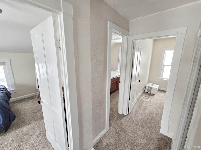 hallway featuring light carpet